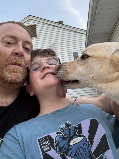 Chef Alan Fucci taking a selfie with his son and their dog